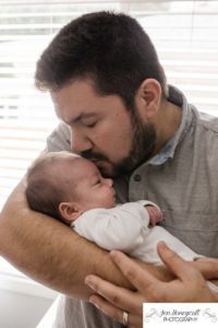 Littleton family photographer father son baby boy newborn new lifestyle nursery in home snuggles kisses love