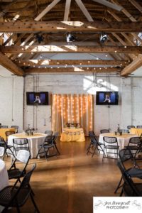 Littleton wedding photographer urban marriage The Studios of Overland Crossing married lights wood beams brick walls