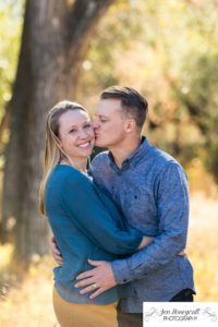 Littleton family photographer couple in love married marriage kiss yellow leaves trees fall in Colorado Lakewood photography 