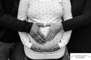 Littleton family photographer maternity session baby bump surrogate surrogacy pregnant pregnancy sisters love heart hands belly bump Lakewood Heritage Center fall in Colorado photography parents to be couples