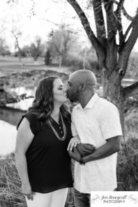 Littleton family photographer engagement session engaged wedding husband and wife to be Lakewood Country Club spring couple in love sunset green golf course bridge stone save the date announcement photography Colorado kiss kissing kisses black and white