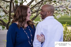 Littleton family photographer engagement session engaged wedding husband and wife to be Lakewood Country Club spring couple in love sunset green golf course save the date announcement photography Colorado white crabapple trees blooming