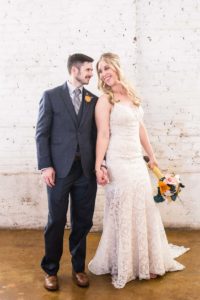 Littleton wedding photographer bride groom The Studios at Overland Crossing white brick wall urban setting in love marriage married