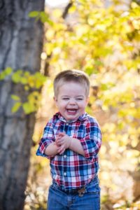 Littleton family photographer little boy toddler happy giggles unposed real outdoor photography Colorado fall yellow leaves trees