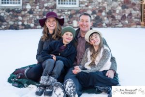 Littleton family photographer Highlands Ranch Mansion Colorado photography foothills snow winter kids children stone wall brick winter hats gloves boots fun