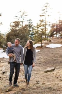 Littleton family photographer walking baby boy mother father son Mt. Falcon park Colorado mountains view mountain forest photography winter light snow spring sunset golden hour baby on the way
