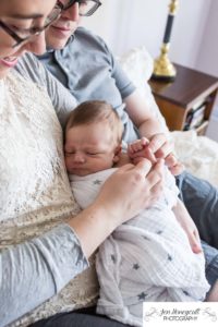 ittleton family photographer in home lifestyle photo session newborn new baby boy Colorado photography nursery parents parenthood mother father crib nursery Highlands Ranch swaddled bonding