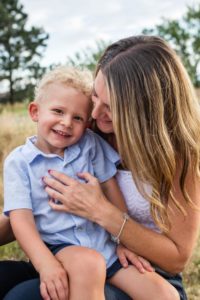 Littleton family photographer mother son bond Lakewood Heritage Center snuggles laughter candid moment real smile little boy Mommy's guy summer sunset light