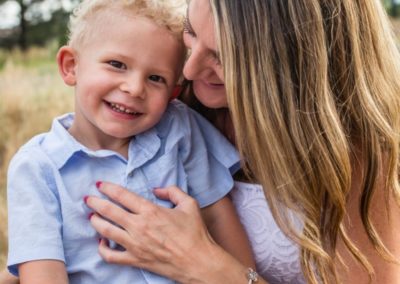 Littleton family photographer mother son bond Lakewood Heritage Center snuggles laughter candid moment real smile little boy Mommy's guy summer sunset light