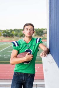 Littleton high school senior portrait photographer Colorado schools photography photo sessions football player at Thunder Ridge Highlands Ranch foothills class of 2020 jersey