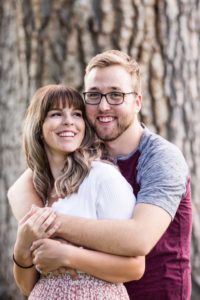 Littleton family couple photographer at Wash Park in Denver Colorado with a married couple in love husband wife snuggles hugs summer golden light