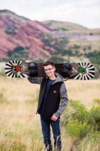 Littleton high school senior portrait photographer Colorado photography senior boy snowboard red rocks rock formations hoodie graduating