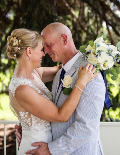 Littleton wedding photographer War Memorial Rose Garden Colorado photography bride and groom in love married marriage outdoor ceremony gazebo summer weather rain sun nose to nose in love flowers dress husband wife I do
