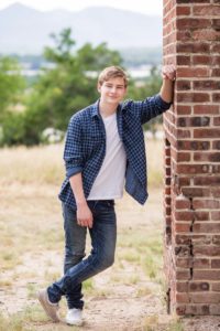 Littleton high school senior portrait photographer Colorado schools photography class of 2020 soccer boy goalie Fly'N B park in Highlands Ranch and Writer's Vista Centennial field net brick wall foothills
