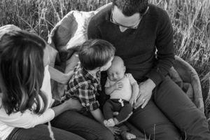 Littleton newborn new baby photographer in Colorado area photography black white big brother little brothers kisses lifestyle love family outdoors in home
