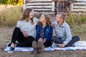 Littleton family photographer in Colorado kid kids children siblings big sister little brother sisters brothers love bond old barn Hildebrand Ranch park fall