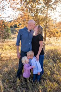 Littleton family photographer in Colorado Ken Caryl Valley foothills photography fall leaves kids brother sister siblings children kisses kissing parenthood marriage married love