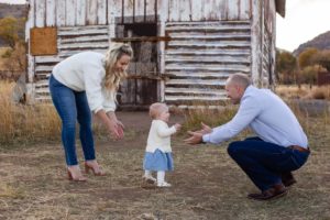 Littleton family photographer in Colorado baby girl walking to her Daddy first steps from Mommy one year old daughter Hildebrand Ranch barn fall