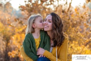 Littleton family photographer in Colorado at Writer's Vista park Centennial Highline Trail fall leaves golden hour sunset light big brother little sister kids children natural smiles real life parenthood mother daughter kiss on the cheek