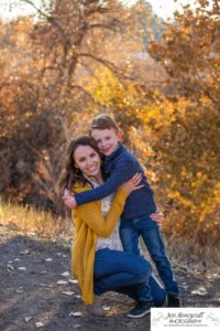 Littleton family photographer in Colorado at Writer's Vista park Centennial Highline Trail fall leaves golden hour sunset light big brother little sister kids children natural smiles real life parenthood mother son hugs