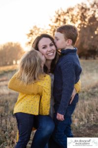 Littleton family photographer in Colorado at Writer's Vista park Centennial Highline Trail fall leaves golden hour sunset light big brother little sister kids children natural smiles real life parenthood kisses for Mommy mom