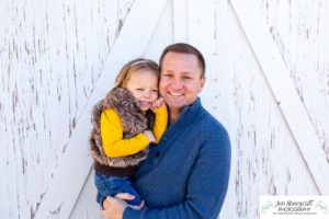 Littleton family photographer in Colorado at the Lakewood Heritage Center with kids children big brother little sister old barns joy Christmas snuggles cold fall winter