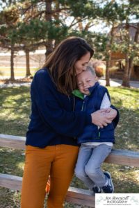 Littleton family photographer in Colorado at the Lakewood Heritage Center with kids children big brother little sister old barns joy Christmas snuggles cold fall winter