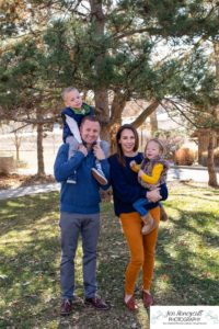 Littleton family photographer in Colorado at the Lakewood Heritage Center with kids children big brother little sister old barns joy Christmas snuggles cold fall winter