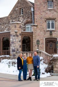 Littlleton family photographer Highlands Ranch Mansion stone building winter snow fall leaves red barn old building metal gate sisters big little girls teen teenagers foothills view at sunset