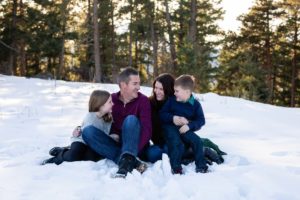 Littleton family photographer in Colorado winter snow mountain view brother sister little big natural light pine trees Mt. Falcon park love bond siblings mother father son daughter mom dad parenthood