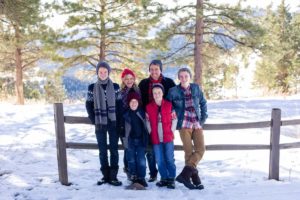 Littleton family teen photographer in Colorado snow mountains view winter wonderland hats boys brothers Mt. Falcon foothills fresh powder photography