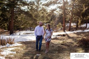 Littleton family maternity photographer in Colorado Mt. Falcon park snow spring baby bump pregnant husband and wife mountain view mountains foothills sunset natural golden light