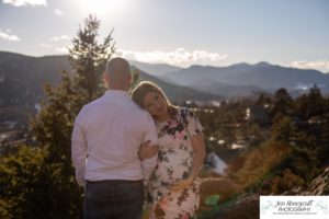 Littleton family maternity photographer in Colorado Mt. Falcon park snow spring baby bump pregnant husband and wife mountain view mountains foothills sunset natural golden light