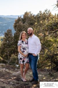 Littleton family maternity photographer in Colorado Mt. Falcon park snow spring baby bump pregnant husband and wife mountain view mountains foothills sunset natural golden light