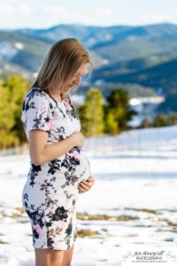 Littleton family maternity photographer in Colorado Mt. Falcon park snow spring baby bump pregnant husband and wife mountain view mountains foothills sunset natural golden light