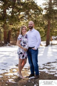 Littleton family maternity photographer in Colorado Mt. Falcon park snow spring baby bump pregnant husband and wife mountain view mountains foothills sunset natural golden light