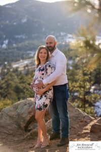 Littleton family maternity photographer in Colorado Mt. Falcon park snow spring baby bump pregnant husband and wife mountain view mountains foothills sunset natural golden light