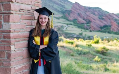 Jordan’s cap and gown photo session at Mt. Falcon with red rocks by Littleton photographer