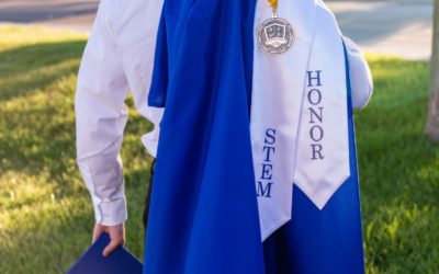 Tyler’s cap and gown senior graduation photo session at STEM school in Highlands Ranch, CO by Littleton photographer