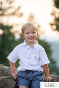 Littleton family photographer in Colorado at Mt. Falcon park mountain views view of foothills boy mother father son love summer sunset natural light photography child three years old