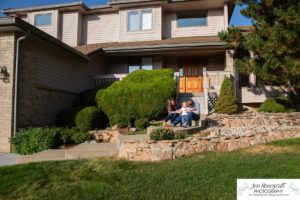 Littleton family photographer one year old boy son father mother porch session home red rocks rock formations Bradford Perley house Ken Caryl Valley toddler walking cute baby