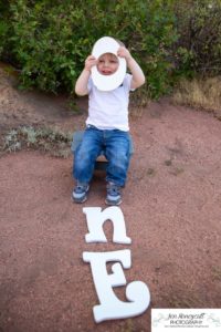 Littleton family photographer one year old boy son father mother porch session home red rocks rock formations Bradford Perley house Ken Caryl Valley toddler walking cute baby