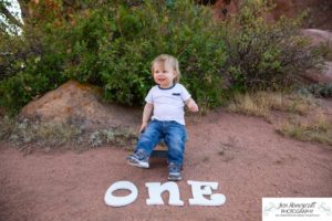 Littleton family photographer one year old boy son father mother porch session home red rocks rock formations Bradford Perley house Ken Caryl Valley toddler walking cute baby