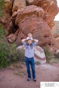 Littleton family photographer one year old boy son father mother porch session home red rocks rock formations Bradford Perley house Ken Caryl Valley toddler walking cute baby