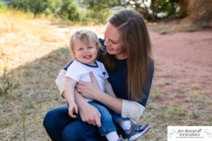 Littleton family photographer one year old boy son father mother porch session home red rocks rock formations Bradford Perley house Ken Caryl Valley toddler walking cute baby