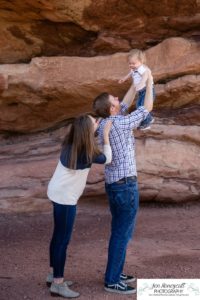 Littleton family photographer one year old boy son father mother porch session home red rocks rock formations Bradford Perley house Ken Caryl Valley toddler walking cute baby