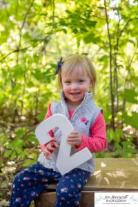 Littleton family photographer Fly'N B park Highlands Ranch fall color change trees baby girl sisters two years old water mother father daughter