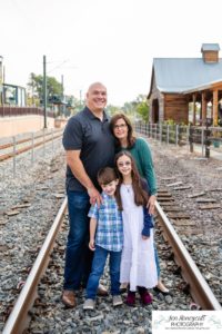 Littleton family photographer in Colorado Olde Town Arvada main street urban flour mill railroad tracks boy girl sister brother siblings mother father son daughter Halloween costume dinosaur zombie