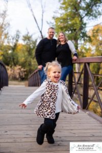 Littleton family photographer Lakewood Stone House bridge happy baby two year old mother father daughter little girl fall photography session outdoor natural light photo