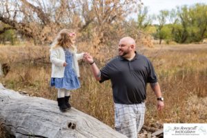 Littleton family photographer Stone House in Lakewood Colorado fall photo session sisters little girls mother father daughters bridge